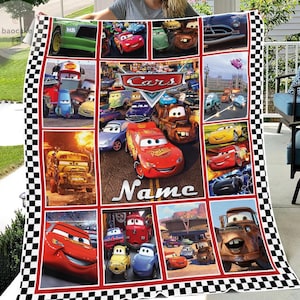 May include: A multi-panel fleece blanket featuring various characters from the Disney Pixar Cars franchise, including Lightning McQueen and Mater, with a checkered border and the word Name printed in white text on a central red car graphic.