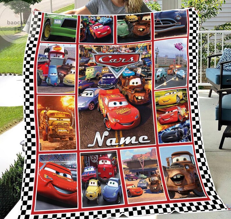 May include: A multi-panel fleece blanket featuring various characters from the Disney Pixar Cars franchise, including Lightning McQueen and Mater, with a checkered border and the word Name printed in white text on a central red car graphic.