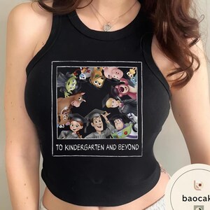 May include: Black vest top with a framed graphic of animated characters wearing graduation caps. The graphic includes the text "TO KINDERGARTEN AND BEYOND" in white lettering. The vest top is sleeveless.