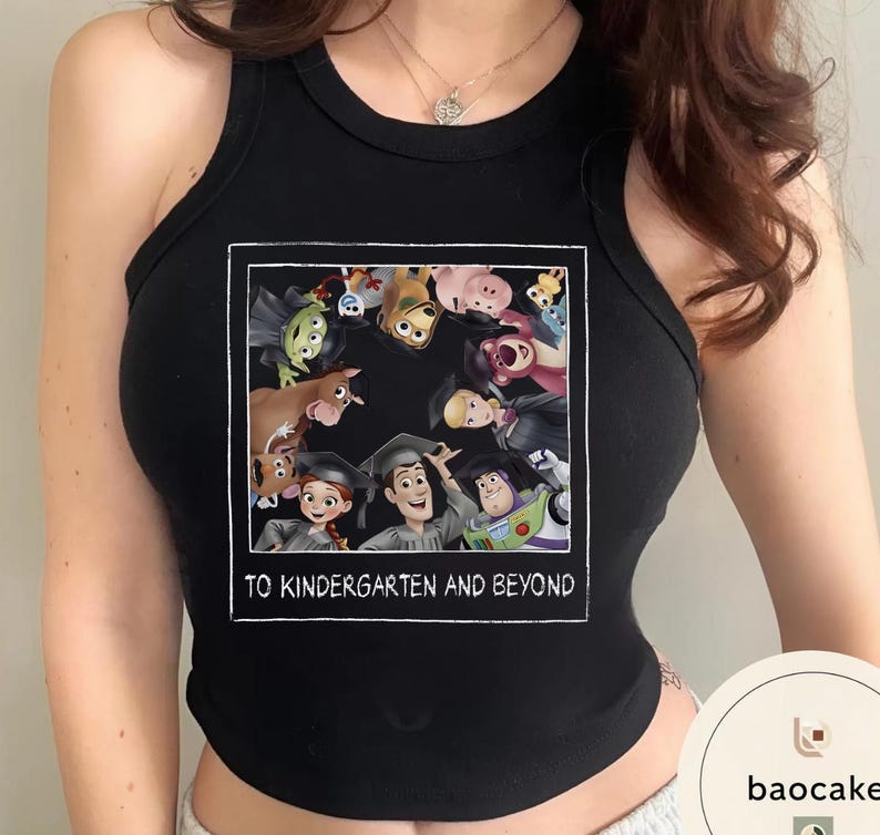 May include: Black vest top with a framed graphic of animated characters wearing graduation caps. The graphic includes the text "TO KINDERGARTEN AND BEYOND" in white lettering. The vest top is sleeveless.
