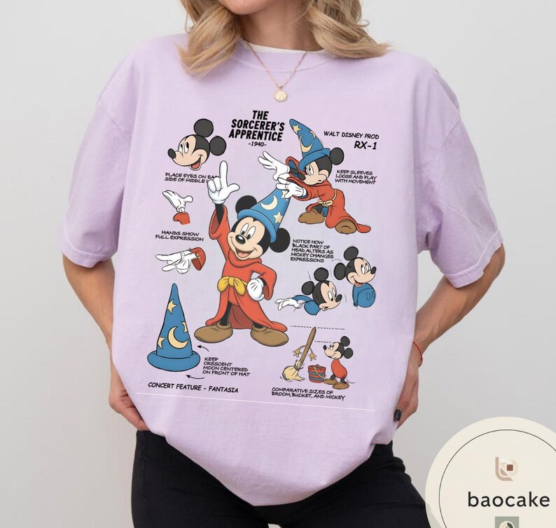 May include: A light purple t-shirt featuring a graphic of Mickey Mouse in his Sorcerer's Apprentice attire. The design includes various poses and text from the 1940s film, with the words "The Sorcerer's Apprentice" and "Walt Disney Prod RX-1".