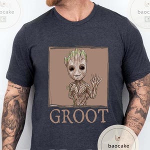 May include: Dark gray t-shirt featuring a Groot graphic. The illustration shows Groot waving with a friendly expression, set within a brown square. The word "GROOT" is printed in brown below the image.