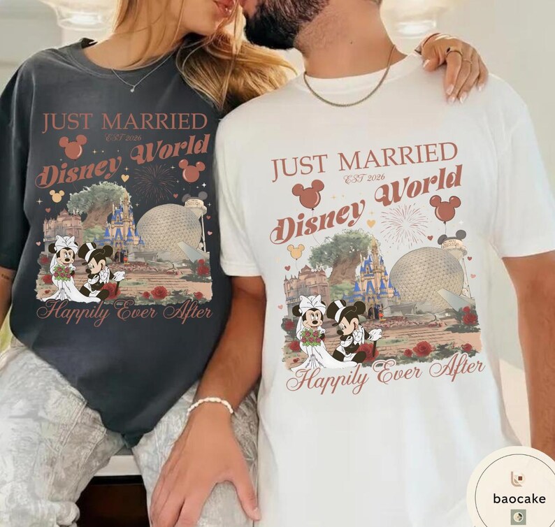 May include: Two t-shirts, one dark gray and one white, featuring a Disney World wedding theme. Each shirt has the text "JUST MARRIED Disney World EST 2026 Happily Ever After" with a graphic of Mickey and Minnie Mouse in wedding attire.