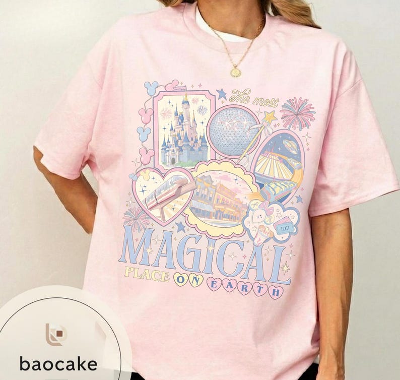 May include: A pale pink t-shirt featuring a vibrant graphic. The design incorporates images of a castle, a globe, a monorail, and other theme park attractions. The words "MAGICAL PLACE ON EARTH" are written in light blue.