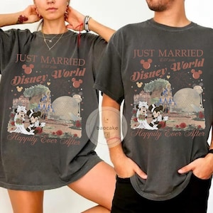 May include: Two charcoal gray t-shirts with a Disney World wedding theme. The shirts feature the text "Just Married" and "Happily Ever After", along with images of Mickey and Minnie Mouse in wedding attire, and Disney World landmarks.