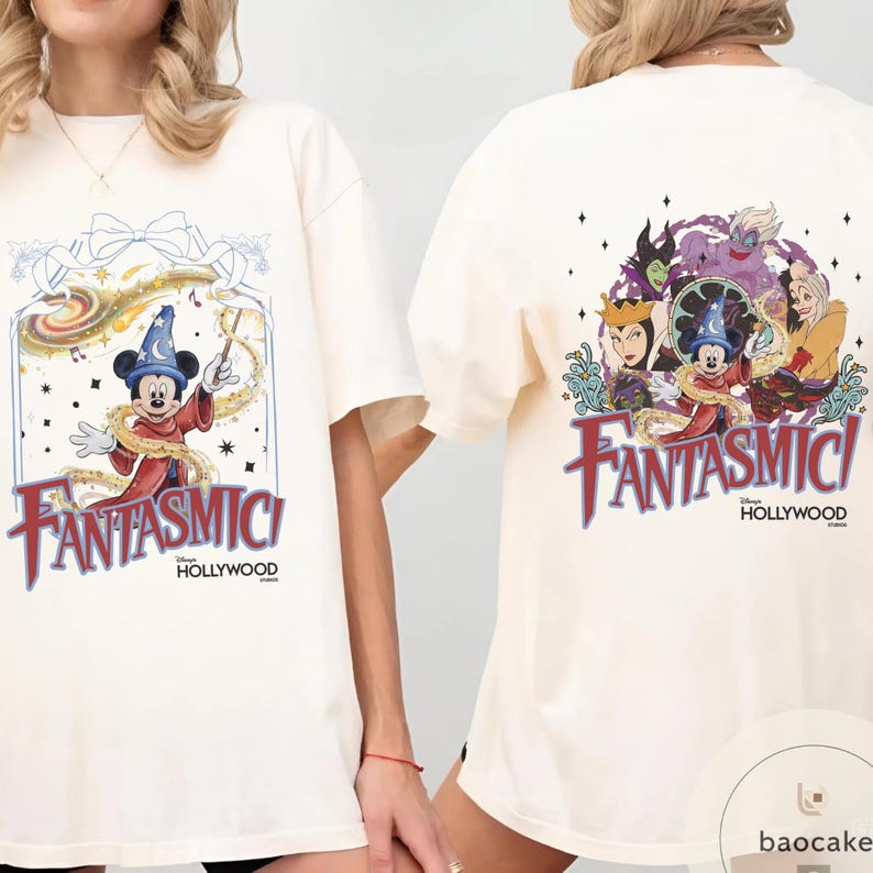 May include: Cream-colored t-shirt featuring a colorful graphic of Mickey Mouse in a sorcerer's hat with the text "Fantasmic! Hollywood" on the front. The back of the shirt displays a group of Disney villains and Mickey Mouse with the same text.