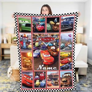 May include: A rectangular fleece blanket featuring a collage of various characters from the Disney Pixar movie Cars, including Lightning McQueen and Mater. The blanket has a black and white checkered border and the word Name printed at the bottom.