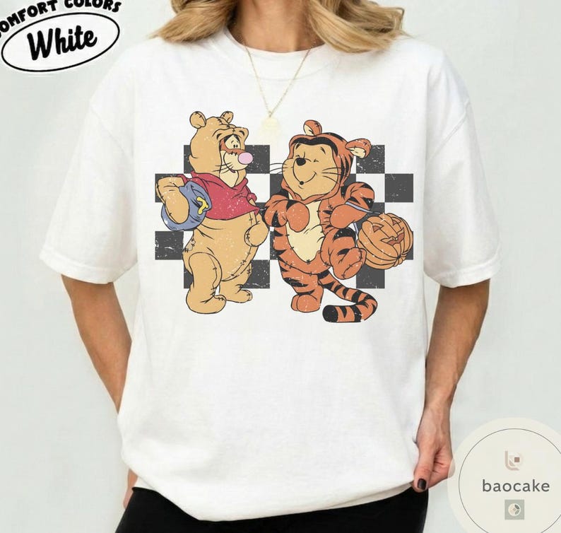 May include: White t-shirt with a distressed graphic featuring two cartoon characters, one dressed as a bear and the other as a tiger, standing in front of a black and white checkered pattern. The text "COMFORT COLORS White" is at the top.