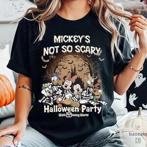 May include: Black t-shirt featuring a Halloween design with Mickey Mouse, Minnie Mouse, Donald Duck, and Goofy in skeleton costumes. The shirt includes the text "Mickey's Not So Scary Halloween Party" and the Walt Disney World logo.