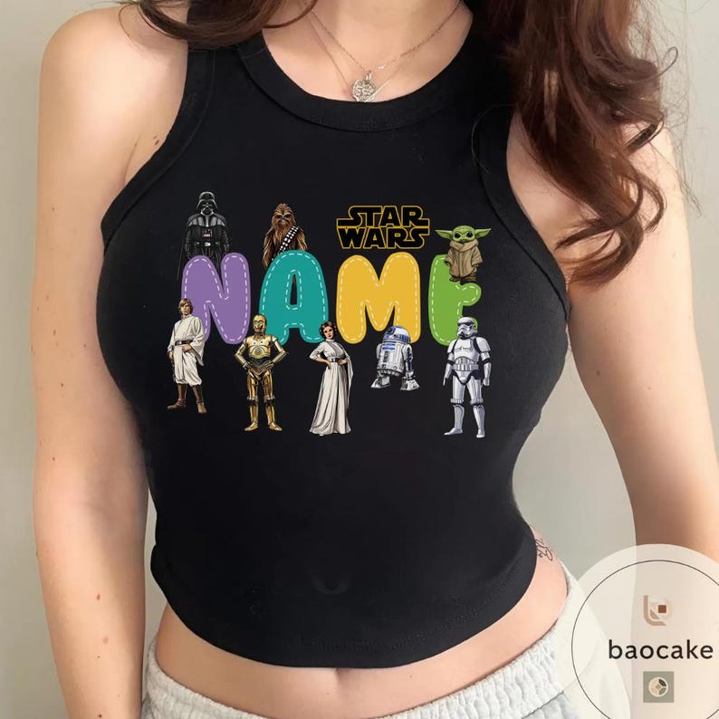 May include: Black tank top featuring Star Wars characters and the word "NAME" in colorful letters. The design includes Darth Vader, Chewbacca, and other iconic characters from the Star Wars franchise.