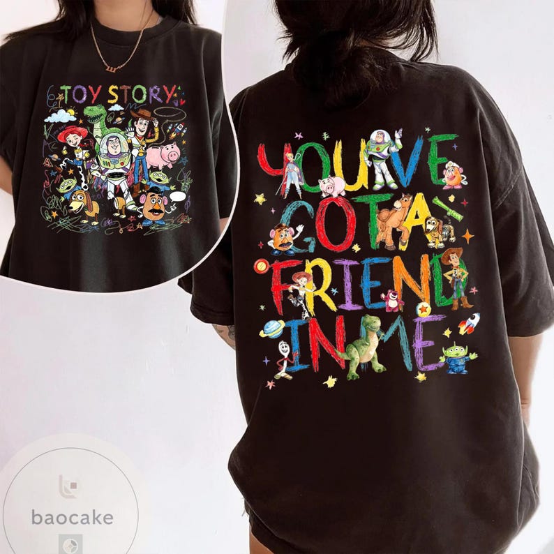 May include: Black t-shirt featuring colorful graphics from the animated film "Toy Story." The front of the shirt displays various characters with the text "Toy Story." The back of the shirt has the phrase "You've Got a Friend in Me" with character illustrations.