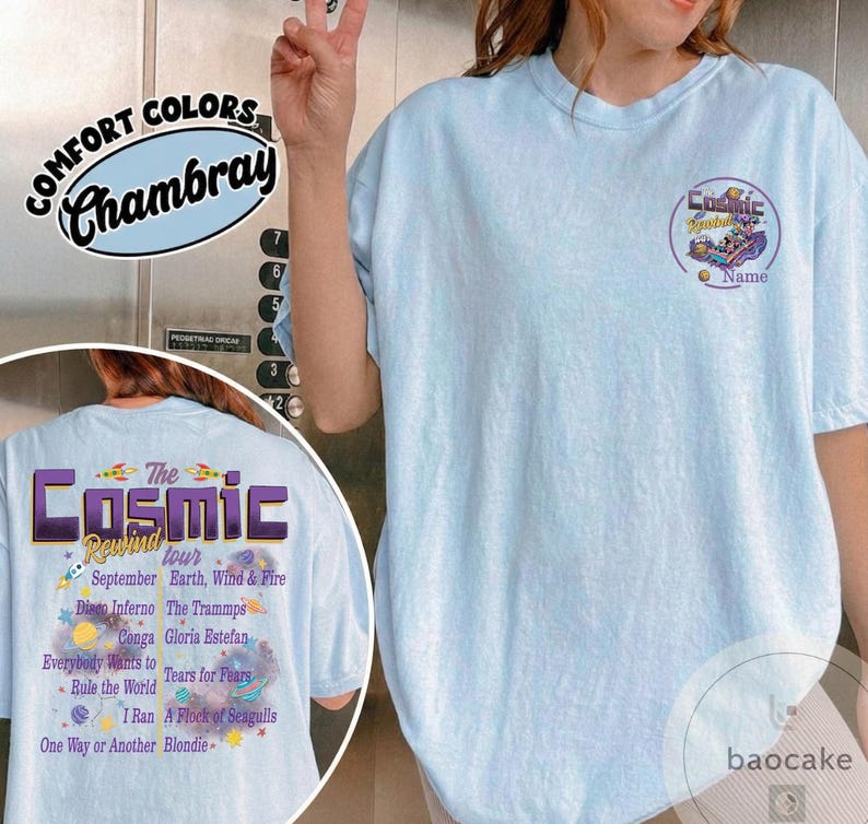 May include: Light blue t-shirt with "The Cosmic Rewind Tour" graphic on the back, featuring a list of bands and the text "September". The front has a smaller graphic and the word "Name". Made of Comfort Colors Chambray.