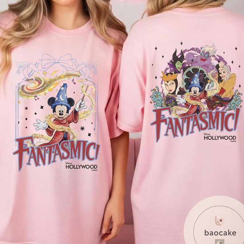 May include: Pink t-shirts featuring the word "Fantasmic!" in a stylized font. One shirt displays Mickey Mouse in a sorcerer's outfit, while the other showcases Disney villains. The shirts also include "Hollywood" text.
