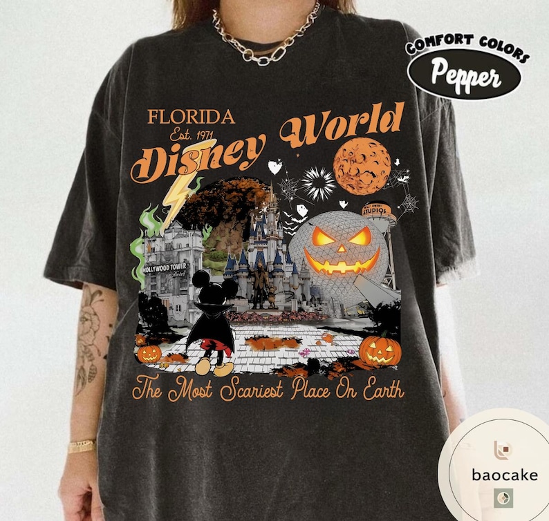 May include: Dark gray t-shirt with a Halloween-themed Disney World graphic. The design includes a castle, a jack-o'-lantern, and the text "Florida Disney World" with the phrase "The Most Scariest Place On Earth."