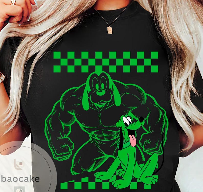 May include: Black t-shirt featuring a green cartoon illustration of Pluto in two poses: a muscular version and a sitting version with its tongue out. The design includes a green and black checkered pattern at the top and bottom.