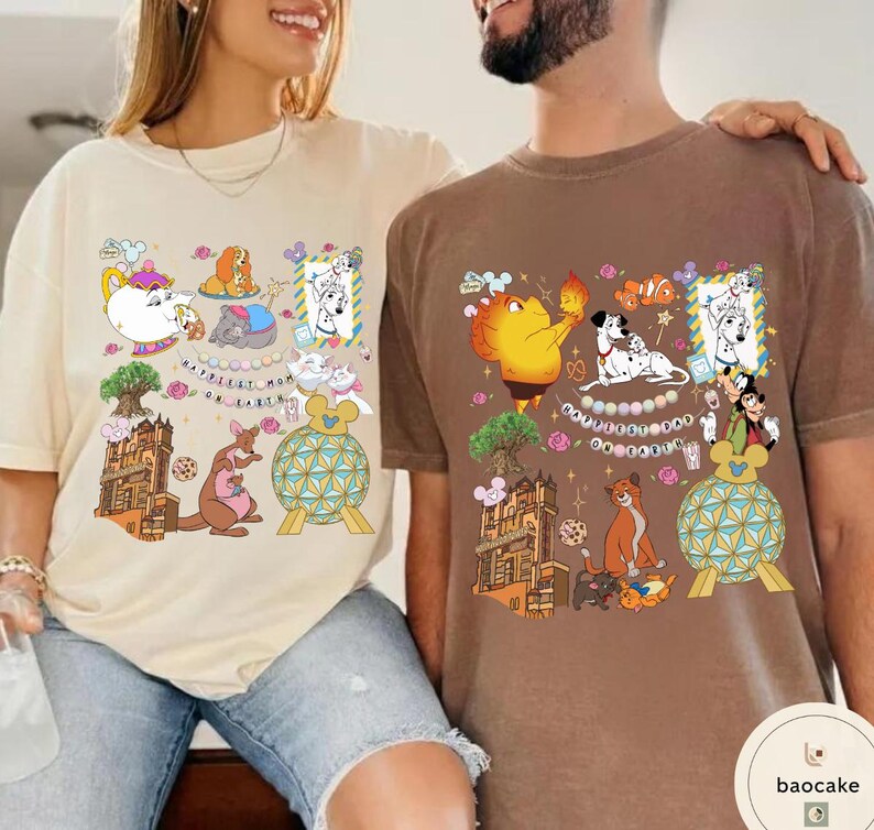 May include: Two t-shirts, one beige and one brown, featuring colorful cartoon designs. The beige shirt has a teapot, kangaroo, and other characters. The brown shirt displays a character holding fire, Dalmatian dogs, and other characters.