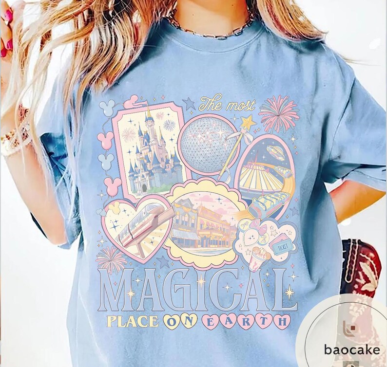 May include: Pale blue t-shirt with a vibrant graphic showcasing theme park imagery, such as a castle and a monorail. The text "The most MAGICAL PLACE ON EARTH" is printed in large letters.