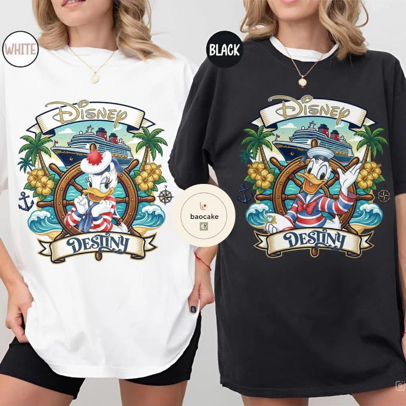 May include: White and black t-shirts featuring a Disney-themed graphic. The design includes Donald Duck at a ship's wheel, a cruise ship, palm trees, and the word "Destiny" on a banner. The Disney logo is at the top.