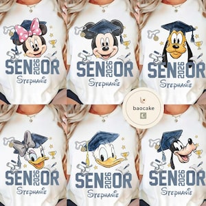 May include: White t-shirts featuring Disney characters in graduation caps. Each shirt has the word "SENIOR 2026" and a name printed below. Minnie Mouse, Mickey Mouse, Goofy, Daisy Duck, and Donald Duck are shown.