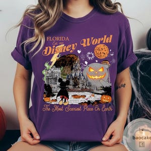 May include: Purple t-shirt with a Halloween-themed Disney World graphic. The design includes a jack-o'-lantern, Mickey Mouse, and the text "Florida Disney World Est. 1971" and "The Most Scariest Place On Earth."