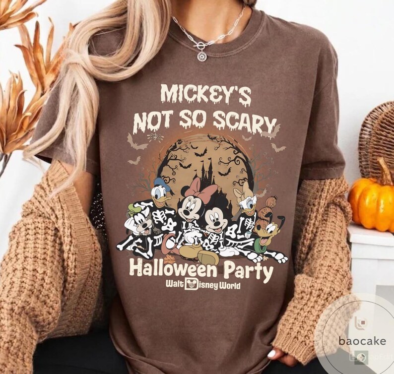 May include: Brown t-shirt with the text "Mickey's Not So Scary Halloween Party" and a graphic of Disney characters in skeleton costumes. The design includes Mickey Mouse, Minnie Mouse, Donald Duck, Daisy Duck, and Goofy. The shirt is from Walt Disney World.