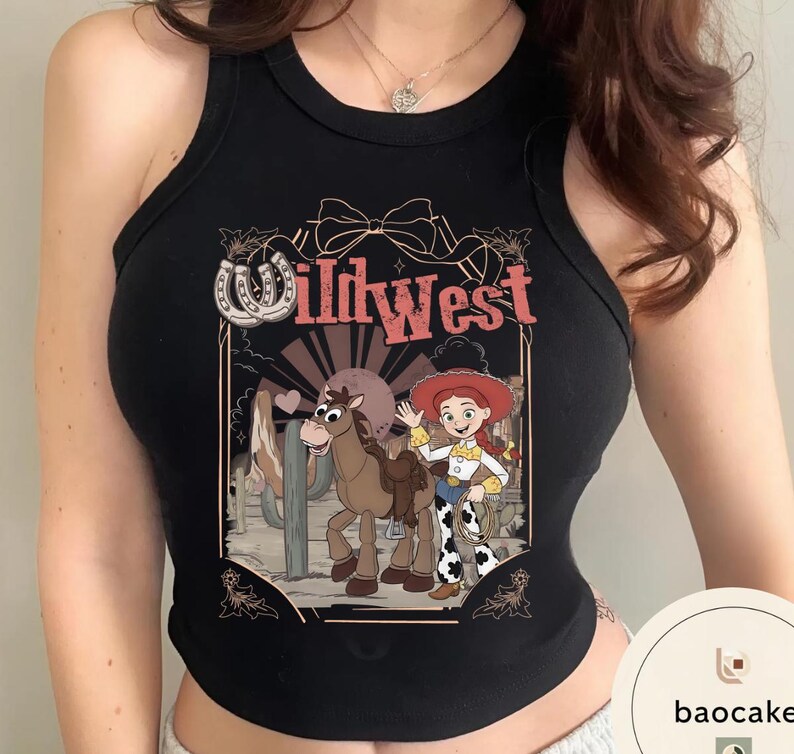 Pu&ograve; includere: Canotta nera con un design Wild West. La grafica include una cowgirl dei cartoni animati, un cavallo e la scritta "Wild West". Il design presenta un ferro di cavallo, un cactus e un fiocco. La canotta &egrave; senza maniche.
