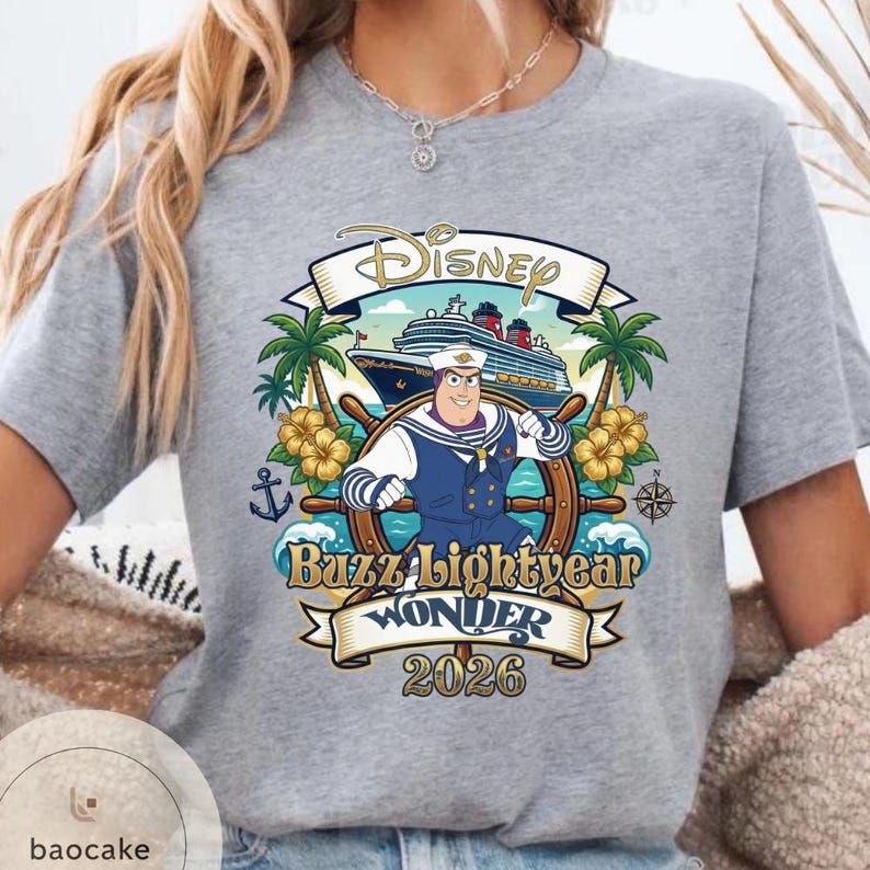 May include: Gray t-shirt featuring a Disney cruise design with Buzz Lightyear as a ship captain. The design includes a cruise ship, palm trees, and the text "Buzz Lightyear Wonder 2026".