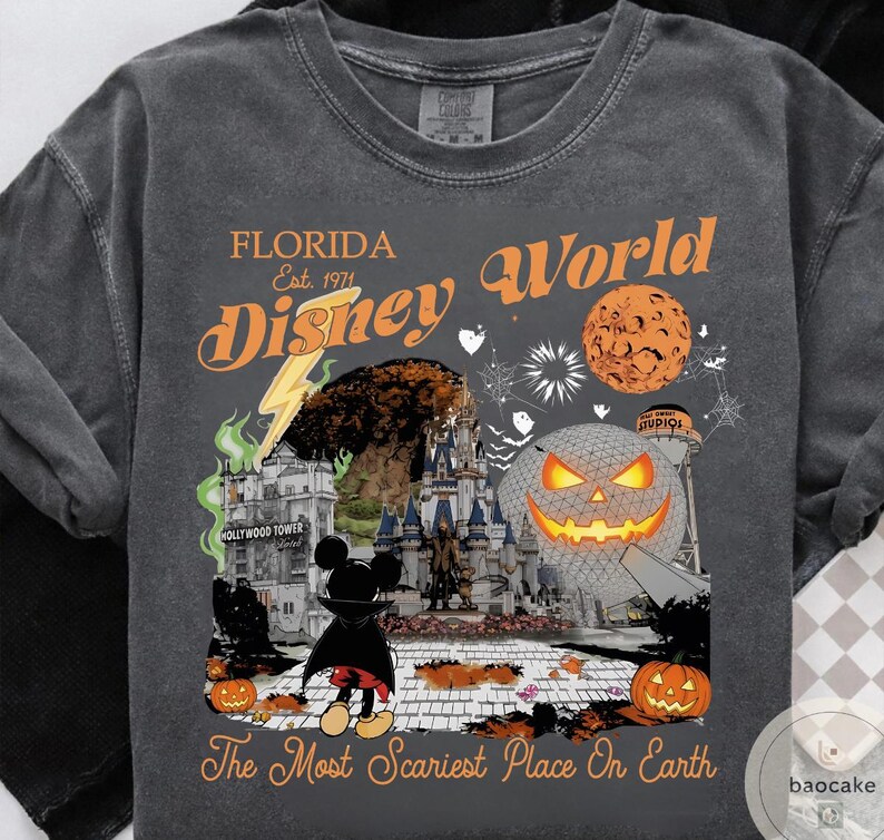 May include: Dark gray t-shirt featuring a Halloween-themed design with the text "Florida Disney World" and "The Most Scariest Place On Earth." The graphic includes a castle, Mickey Mouse, pumpkins, and a jack-o'-lantern.