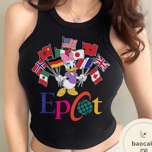 May include: Black vest top with a colourful graphic of Daisy Duck holding flags from different countries. The word "Epcot" is printed in multiple colours below the character, with a globe graphic replacing the "o".