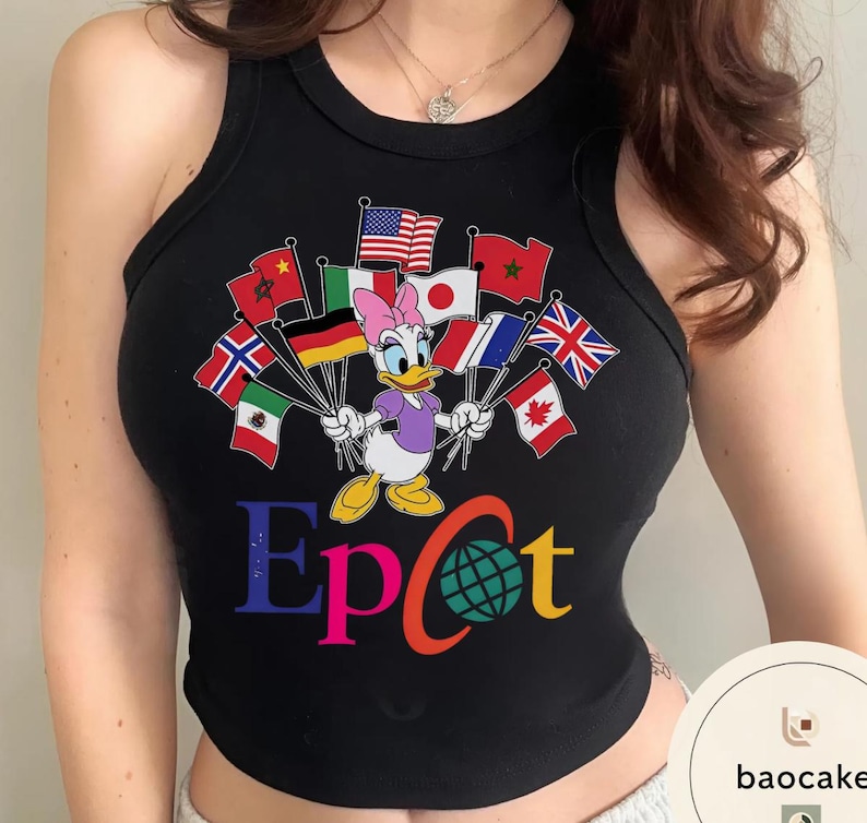 May include: Black vest top with a colourful graphic of Daisy Duck holding flags from different countries. The word "Epcot" is printed in multiple colours below the character, with a globe graphic replacing the "o".