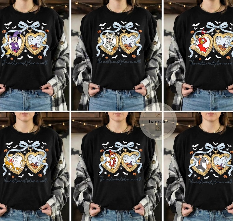 May include: Black long-sleeved top with a Halloween graphic. The design features a heart-shaped locket with cartoon characters, pumpkins, bats, and the text "The most scariest place on earth". A light blue bow and ribbon complete the design.