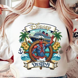 May include: White sweatshirt featuring a graphic of Spider-Man in a sailor outfit at the helm of a ship. The design includes the words "Disney" and "Destiny", palm trees, and a cruise ship.