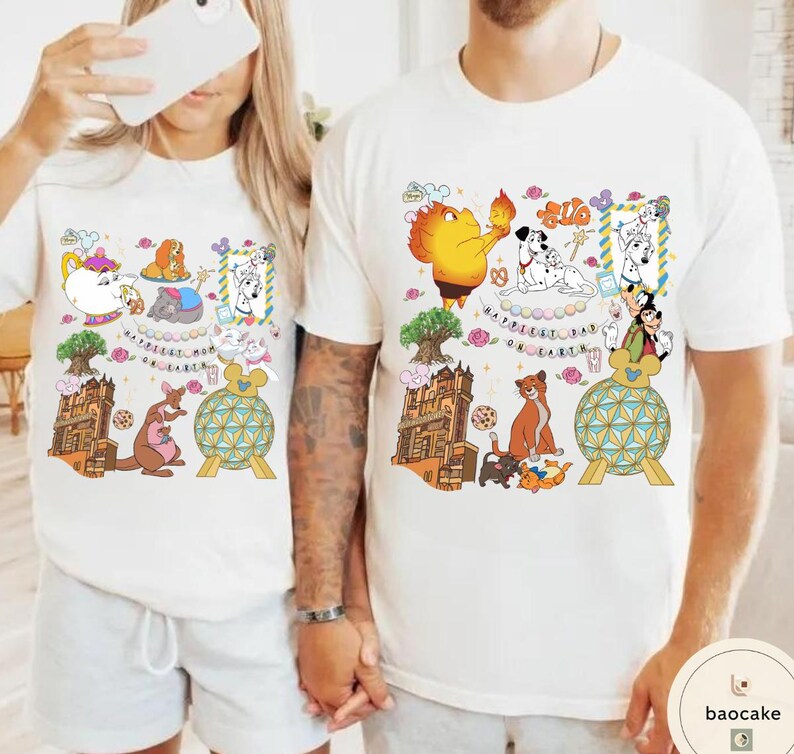 May include: White t-shirts with colorful cartoon character graphics. One shirt features a kangaroo, teapot, and other characters. The other shirt has a lion, dalmatian dogs, and other characters. The text on the shirts reads "Happiest Day on Earth."