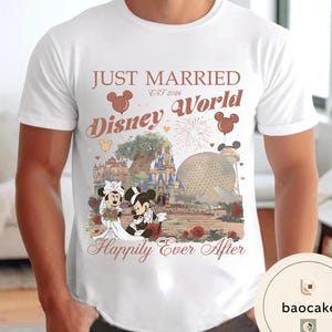 May include: White t-shirt with a Disney World wedding design. The shirt features the text "Just Married Disney World Happily Ever After" with Mickey and Minnie Mouse in wedding attire, and the date "EST 2026".