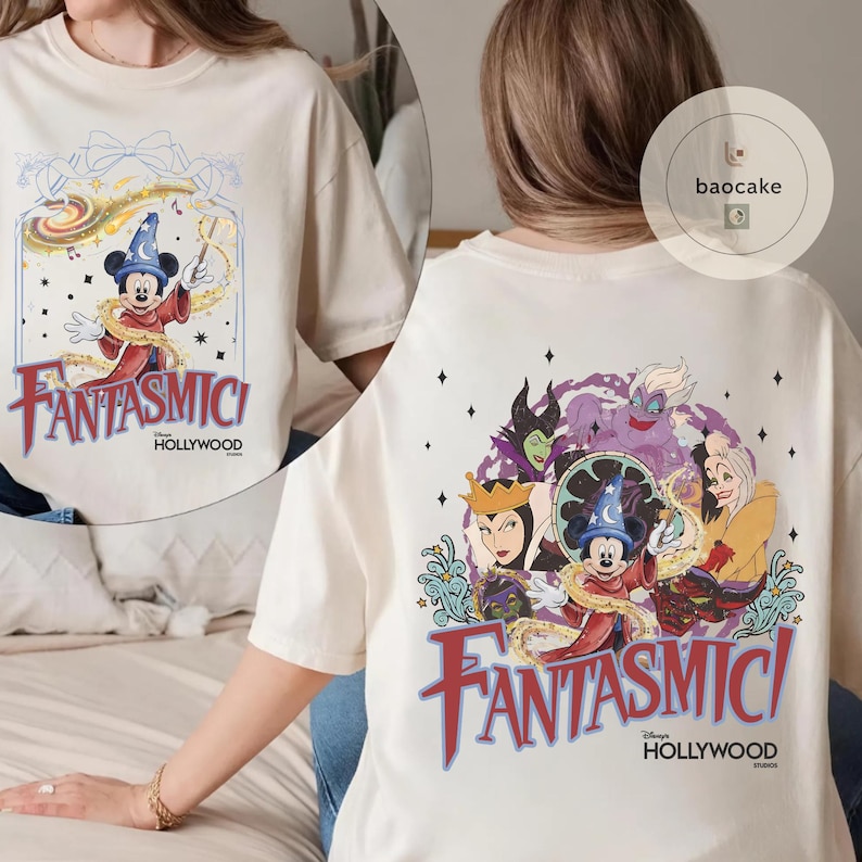 May include: Cream-colored t-shirt featuring a colorful graphic of Mickey Mouse in a sorcerer's hat, with the text "Fantasmici Hollywood" in red and blue. The back of the shirt shows various Disney villains and Mickey Mouse.
