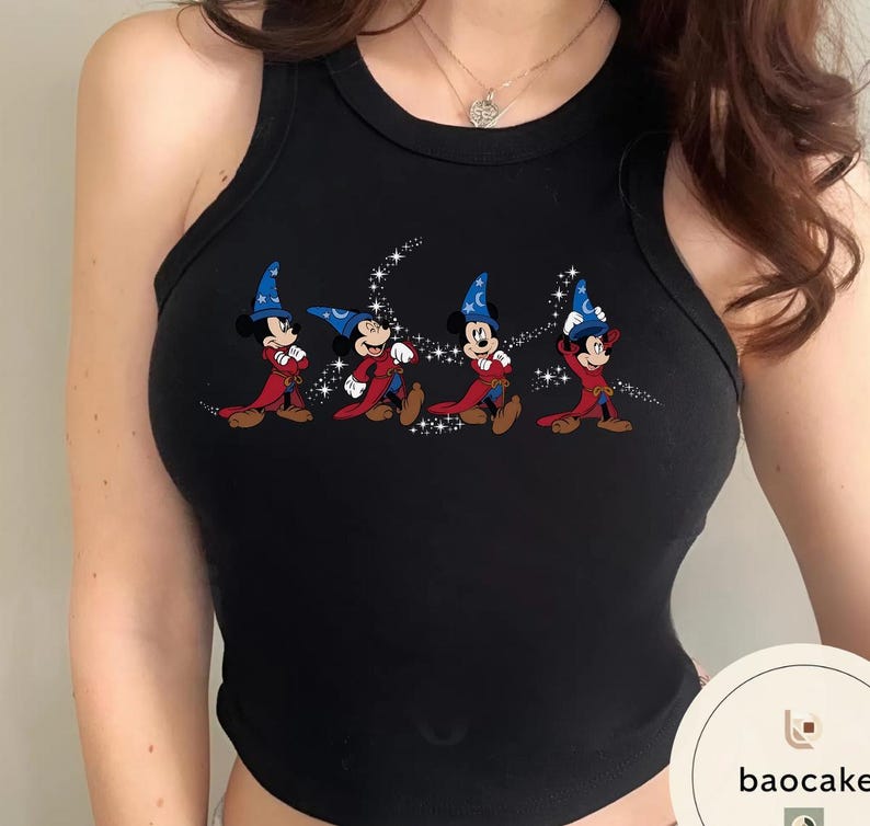 May include: Black tank top featuring a graphic of Mickey Mouse in a wizard costume. The cartoon Mickey Mouse is wearing a blue wizard hat and red robe. The design is accented with sparkling stars.