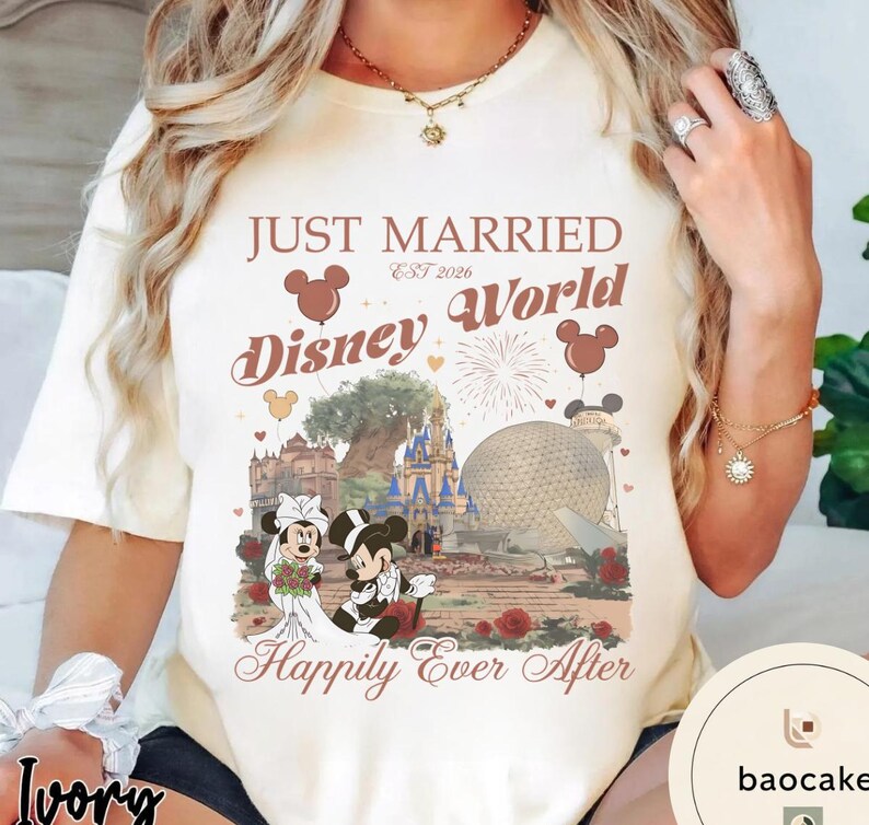 May include: Ivory-colored t-shirt with a Disney World wedding theme. The shirt features the text "Just Married Disney World Est 2026" with Mickey and Minnie Mouse in wedding attire, and the phrase "Happily Ever After."
