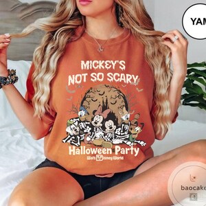May include: Orange t-shirt with the text "Mickey's Not So Scary Halloween Party" and Disney characters in skeleton costumes. The design includes bats, a full moon, and the Walt Disney World logo.