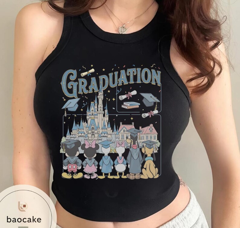 May include: Black tank top with a colorful graphic featuring Disney characters in graduation attire in front of a castle. The word "Graduation" is printed in blue above the castle and graduation caps.