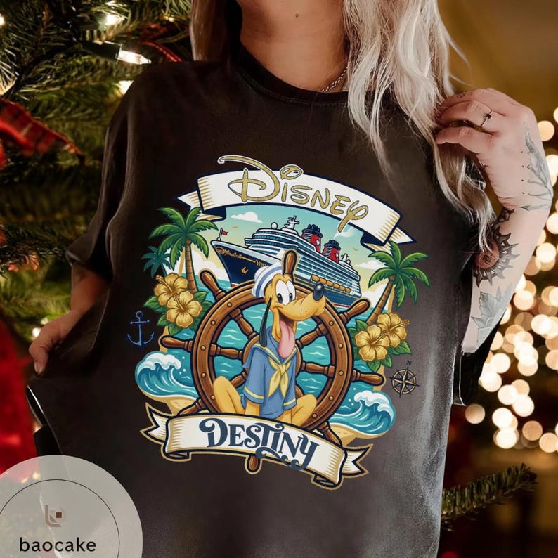 May include: Dark brown t-shirt featuring a colorful Disney design. The graphic includes Pluto at a ship's wheel, a cruise ship, palm trees, and the words "Disney" and "Destiny" in a banner.