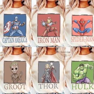 May include: Cream-colored sweatshirts featuring six different Marvel superheroes: Captain America, Iron Man, Spider-Man, Groot, Thor, and Hulk. Each superhero is depicted in a square frame with their name below. The designs are in a cartoon style.