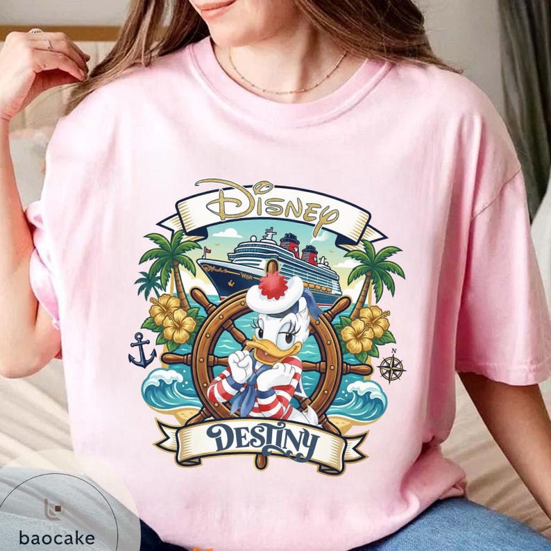 May include: Pink t-shirt featuring a Disney cruise design. The graphic includes a ship, palm trees, and Donald Duck at the helm. The word "Disney" is arched across the top, and "Destiny" is at the bottom.