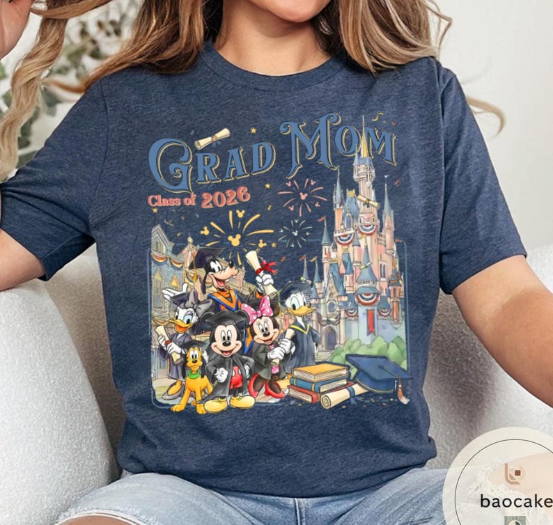 May include: Navy blue t-shirt with a colourful graphic featuring the text "Grad Mom Class of 2026" and a Disney castle. The graphic includes Mickey Mouse, Minnie Mouse, Donald Duck, and Goofy in graduation attire.