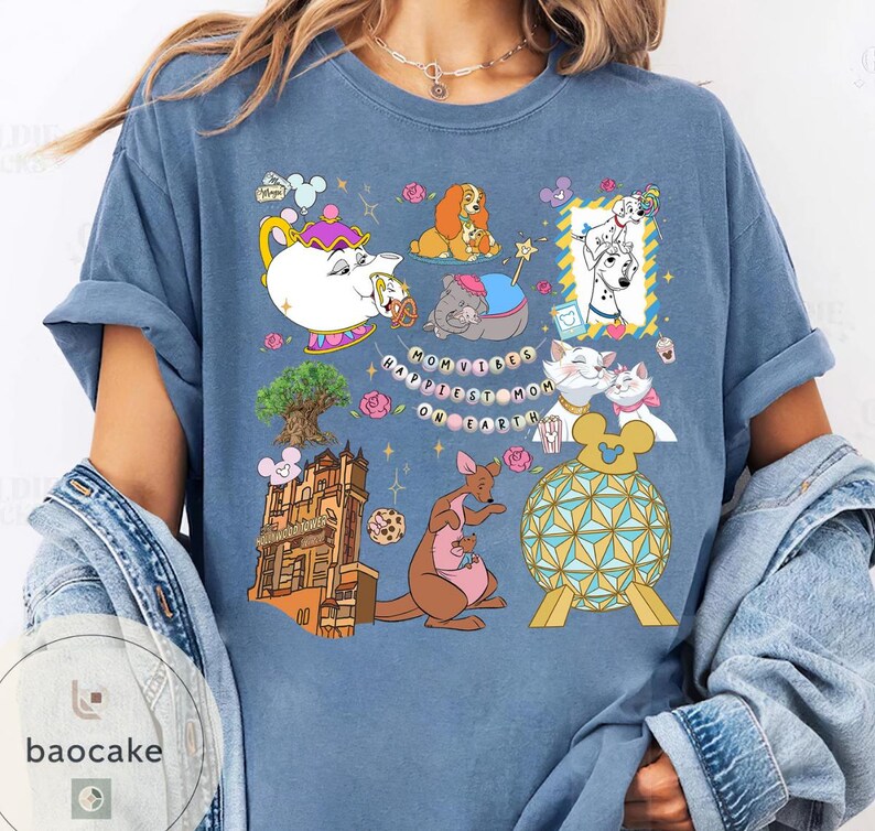 May include: A blue t-shirt featuring various cartoon characters and icons. The shirt includes images of a teapot, dogs, cats, a kangaroo, and a building. The text "Happiest Mom on Earth" is also present.