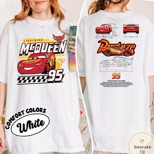 May include: A white t-shirt featuring Lightning McQueen from the movie Cars. The front displays the character, the text Lightning McQueen, and the number 95. The back shows technical diagrams of the car, the Rust-eze logo, and descriptive text.