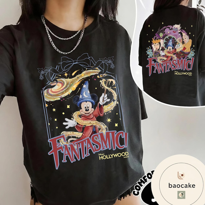 May include: Black t-shirt featuring a colorful graphic of Mickey Mouse in a wizard outfit with the text "Fantasmic! Hollywood". The back of the shirt shows a group of Disney characters. The shirt has a vintage, distressed look.
