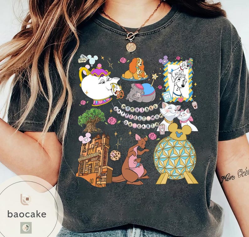May include: Dark gray t-shirt featuring a colorful graphic with Disney characters and landmarks. The design includes images of a teapot, dogs, cats, a kangaroo, and the text "Happiest Mom on Earth."