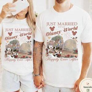 May include: Matching white t-shirts with a Disney World theme. The shirts feature the text "JUST MARRIED Disney World" with Mickey and Minnie Mouse in wedding attire, along with the phrase "Happily Ever After."