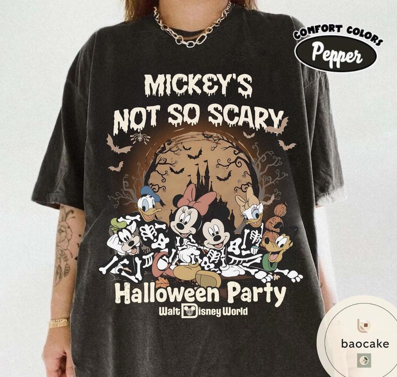 May include: Dark gray t-shirt featuring a Halloween-themed graphic. The design includes the text "Mickey's Not So Scary Halloween Party" with Disney characters in skeleton costumes. The shirt has a Comfort Colors Pepper label.