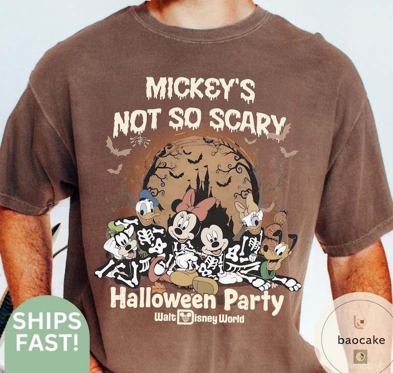 May include: Brown t-shirt featuring a Halloween design with Mickey Mouse, Minnie Mouse, Donald Duck, and Goofy dressed as skeletons. The shirt has the text "Mickey's Not So Scary Halloween Party" and "Walt Disney World".